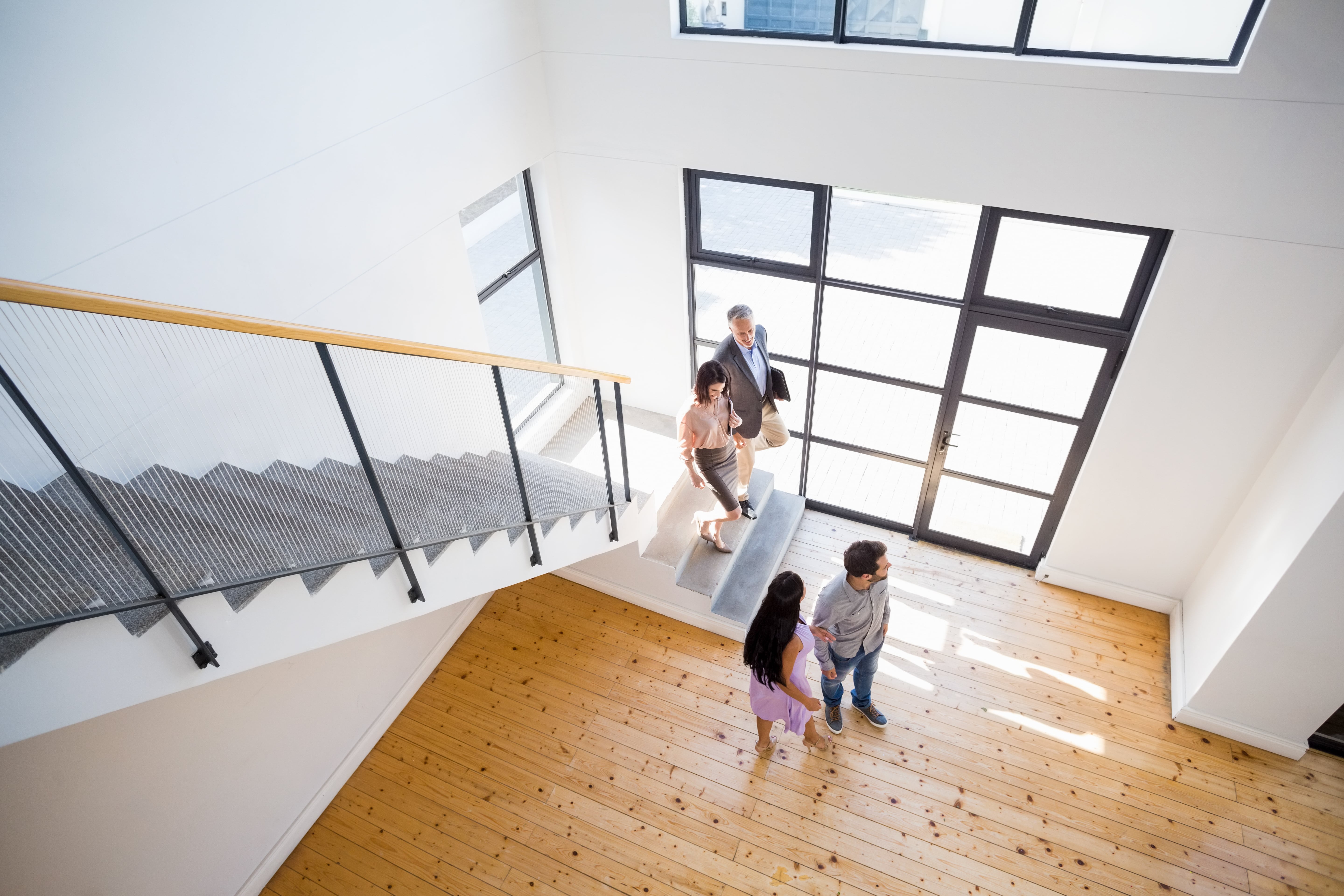 a couple being shown around a bright flat during a viewing
