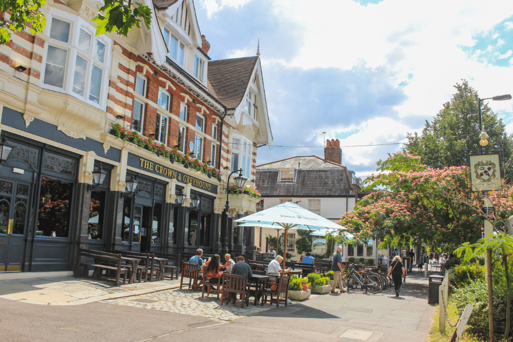 people sat outside a pub in dulwich on picnic benches