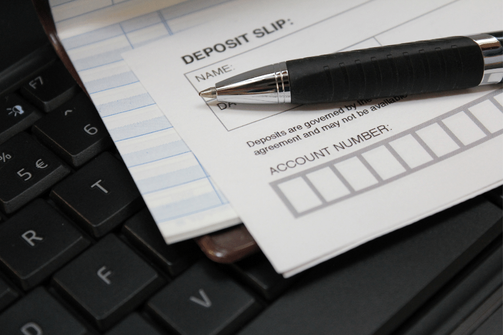 deposit paying in slip with a pen on the form