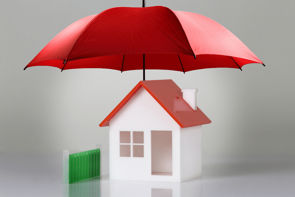 white plastic house under a red umbrella