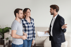 male landlord in suit talking to a pair of tenants