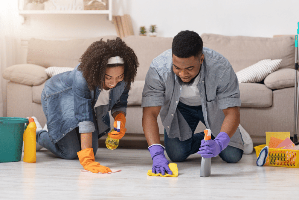 couple cleaning the floor of their home