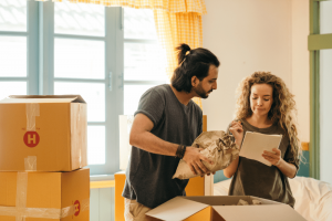 couple moving into a new property and unpacking boxes