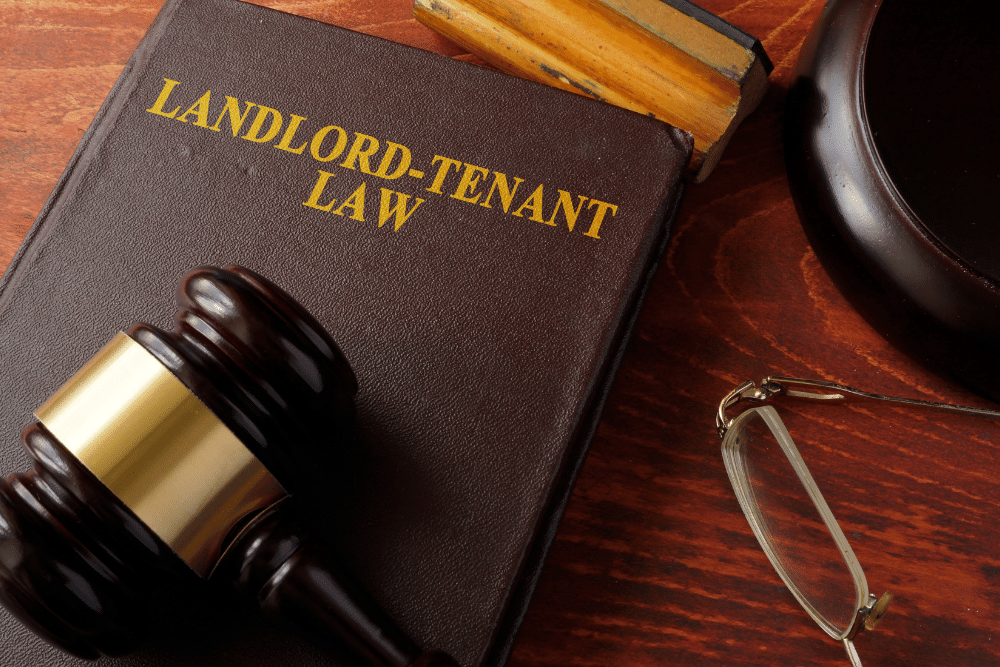 a landlord-tenant law book with a gavel on it