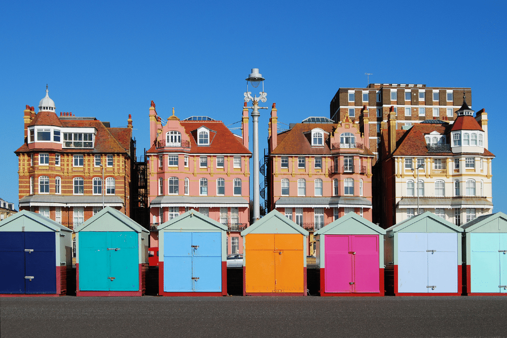 multicoloured beach huts on brighton beachfront 