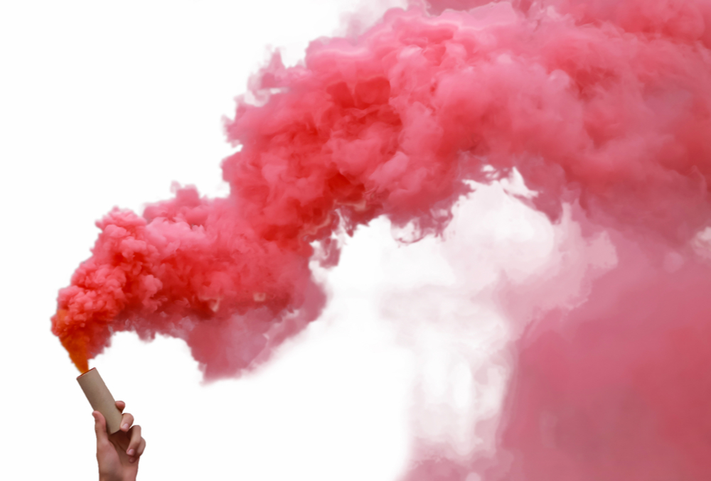 Smoke bombs with red smoke, isolated on white background.