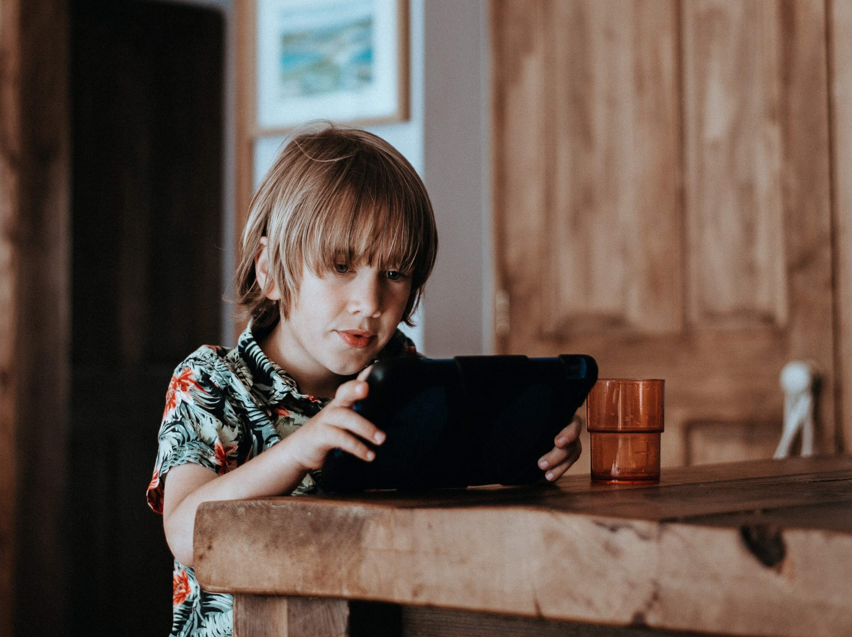 kid playing on a tablet